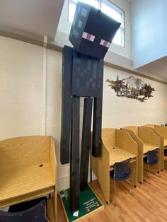 an empty classroom with wooden desks and minecraft characters on the wall behind them