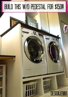 a washer and dryer sitting in a room with white cabinets on the wall