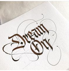 some type of calligraphy that looks like it has been written in brown on white paper