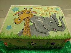 a birthday cake with an elephant and giraffe on it