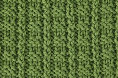 close up view of the crochet stitches on this green knitted afghan pattern