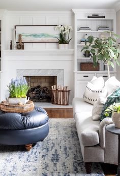 a living room filled with furniture and a fire place in the middle of the room