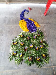 a peacock made out of flowers on the ground