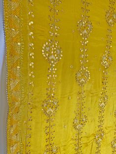 This elegant traditional Yellow Gold Bridal Phulkari Dupatta is expertly crafted from Pure Chinon Silk, with Gotta Patti and phulkari hand embroidery all over. The perfect choice for weddings, sangeet, jaago, and chunni ceremonies. Material: Pure silk chinon Work: Silk thread phulkari handwork, needlework, gotta patti work Pattern: Floral Size: Full Size 2.5 meters Dispatched in 1-3 business days Product Note:​ This is a handcrafted product from artisans and producer groups and due to the nature Phulkari Pants, Gotta Patti Work, Brand Vision, Bridal Dupatta, Phulkari Dupatta, Gotta Patti, Velvet Shawl, Work Pattern, Beautiful Suit