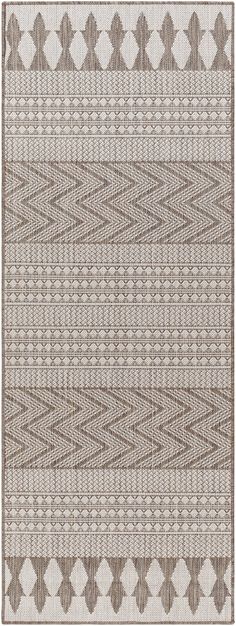 a beige and white rug with an abstract design