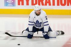 a hockey player is sitting on the ice