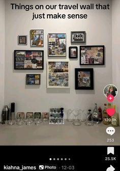 there is a wall with pictures on it and wine glasses in front of the photo