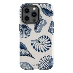 an iphone case with blue shells and seashells printed on the back, in white