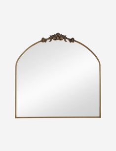 an ornate gold framed mirror on a white wall