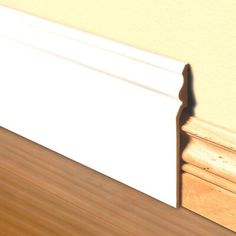 the corner of a room with wood flooring