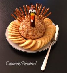 a plate with crackers and a turkey made out of crackers sitting on top of it