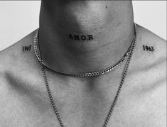 black and white photograph of a man's neck with the word armor tattooed on his chest