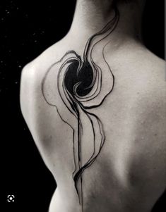 a woman's back with a tattoo on it