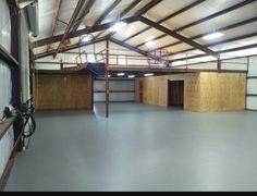 an empty garage with basketball hoops on the wall