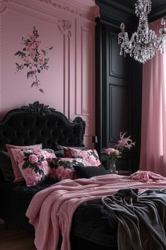 a bedroom with pink walls, black furniture and a chandelier hanging from the ceiling