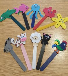 a group of children's hair clips with animals and birds on them sitting on a table