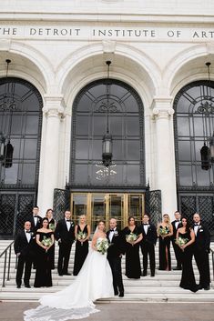 a bride and groom with their bridal party in front of the detroit institute of art