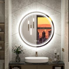 a bathroom with a round mirror above the sink