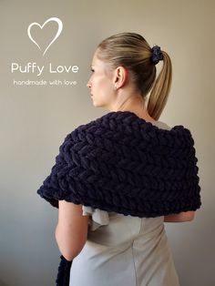 a woman wearing a black knitted shawl with the words puffy love on it