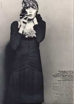 a black and white photo of a woman with her hands on her face in front of an open book