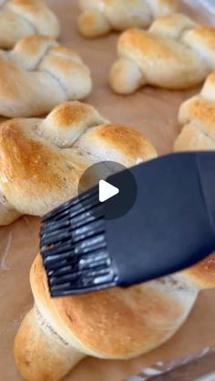 bread rolls being brushed with a hair brush