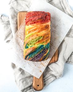 a loaf of rainbow bread sitting on top of a cutting board