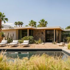 a house with a swimming pool surrounded by palm trees