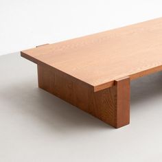 a wooden table sitting on top of a white floor