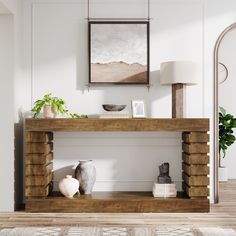 a living room with white walls and wooden furniture on the shelf next to a painting