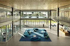 the interior of a modern office building with large windows and blue rugs on the floor