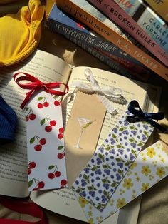 an open book sitting on top of a table next to some ties and bookshelves