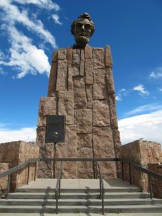 there is a large stone monument with a statue on it's head and stairs leading up to it