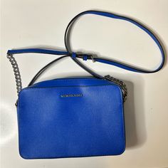 Michael Kors Crossbody Purse: This Bag Is A Gorgeous Bright Blue, Brand New, Never Used. My Husband Bought It For Me But I Unfortunately Just Don’t Like Purses With Chains On The Strap. It’s A Stunning Purse So I Want Someone Who Will Love It To Put It To Good Use! Please See Photos For Measurements. Comment With Any Questions ! Blue Travel Bag With Chain Strap, Michael Kors Blue Shoulder Bag For Travel, Michael Kors Blue Bag For Shopping, Blue Michael Kors Shopping Bag, Blue Michael Kors Bag For Shopping, Blue Bags With Branded Hardware, Michael Kors Blue Shoulder Bag For Everyday Use, Blue Michael Kors Shoulder Bag, Michael Kors Blue Evening Bag