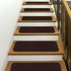 a set of stairs with carpeted treads leading up to the second floor