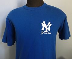 "Vintage 1980's dark blue and white New York Yankees t-shirt. Size: XL, 46-48 (fits more like ADULT MEDIUM) Brand: Stedman Super 50 50% cotton, 50% polyester The shirt is very soft and in very good vintage condition, with no stains - though 2 small holes on back. Approximate measurements with garment laying flat (INCHES): Length (from top of shoulder at collar seam to bottom) : 27\" Sleeve (from top of shoulder seam to cuff edge) : 8.5\" Between Shoulder Seams : 18.5\" Underarm to Underarm : 19. Yankees T Shirt, Vintage New York, Vintage Hoodies, 80s Vintage, Mlb Baseball, Baseball T Shirt, Aesthetic Vintage, New York Yankees, 50 50