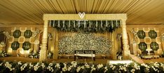 a decorated stage with white flowers and greenery