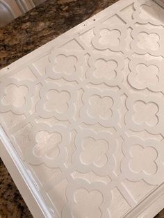 a close up of a tray on a counter top with paper cutouts in the shape of hearts