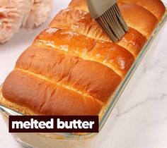 a loaf of bread being spread with a spatula