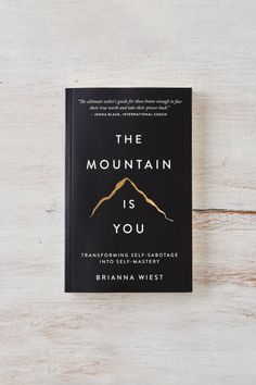 the mountain is you book sitting on top of a wooden table