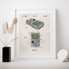 a framed print of an old school gameboy from the'80s and'80s