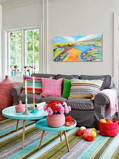 a living room filled with furniture and colorful pillows