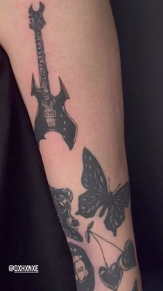 a person with a guitar tattoo on their arm