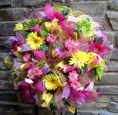 a bouquet of colorful flowers in front of a brick wall