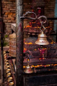 an old metal bell sitting on top of a pole