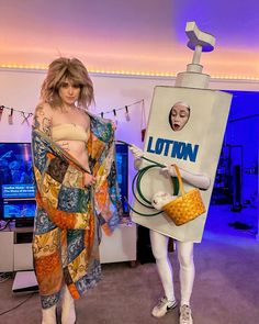 two mannequins dressed in costumes stand next to a sign that reads lotion