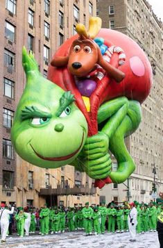 a large balloon is being flown in the shape of a cartoon character and an alien