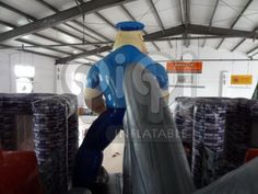 an inflatable man is walking through the warehouse