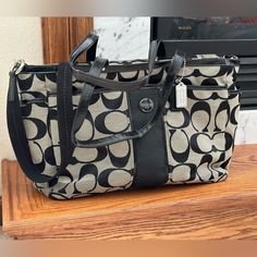 Coach Multifunctional Baby Tote Bag. In Great Shape; The Handles Have Lost Some Shape And There Is A Small Stain On The Bottom (See Pic) But Otherwise Very Clean. * Inside Zip, Cell Phone And Multifunctional Pockets * Approximately 15 1/4" (L) X 11 3/4" (H) X 5 1/2" (W), Handles With 10 1/2" Drop * Longer Strap For Shoulder Or Crossbody Wear, Zip-Top Closure, Fabric Lining * Outside Zippered And Open Pockets Model 21865 Classic Gray Travel Bag, Classic Gray Tote Bag, Black Rectangular Diaper Bag With Top Carry Handle, Black Tote Diaper Bag With Top Carry Handle, Coach Gray Shopping Bags, Gray Rectangular Coach Bag, Elegant Gray Coach Bag, Coach Gray Tote Shoulder Bag, Coach Gray Rectangular Shoulder Bag