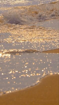 the water is splashing onto the beach