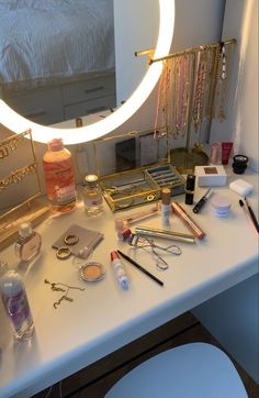 a vanity with makeup, eyeliners, and other items on top of it